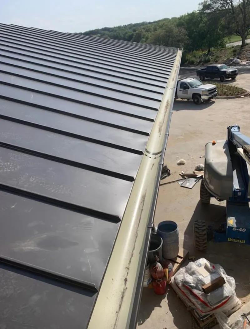 Standing seam panel and gutter detail on a metal roofing jobsite in Bay Point